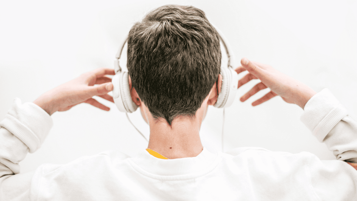 back of young person wearing headphones