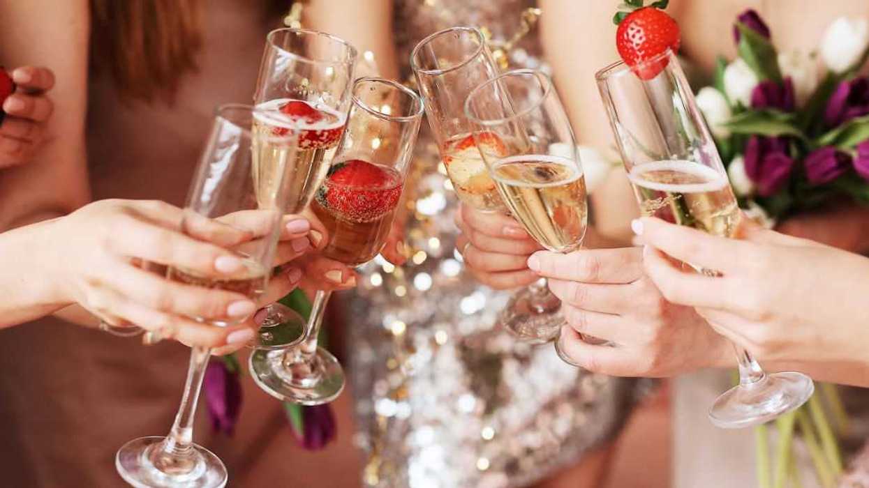 Beautiful young women's hands hold glasses of champagne. Women's party.