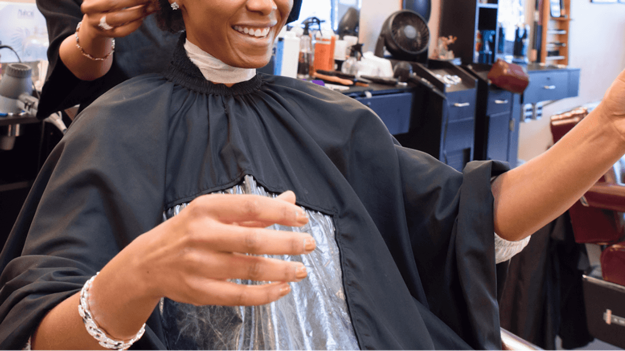 Black woman getting her hair done.