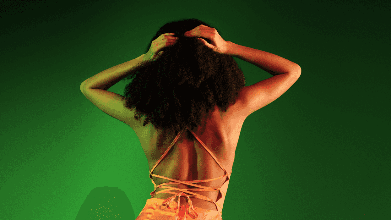 Black woman in backless dress