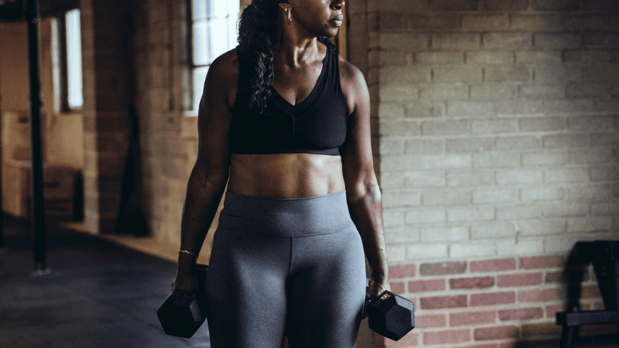 Black woman working out at the gym