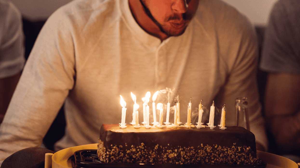 blowing out candles on birthday cake