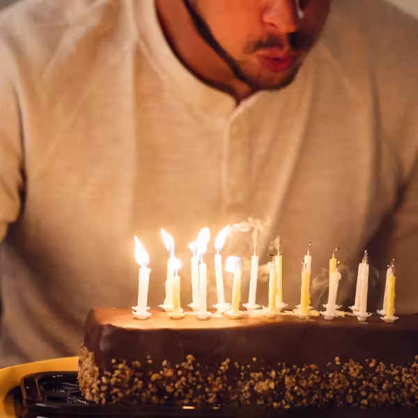 blowing out candles on birthday cake