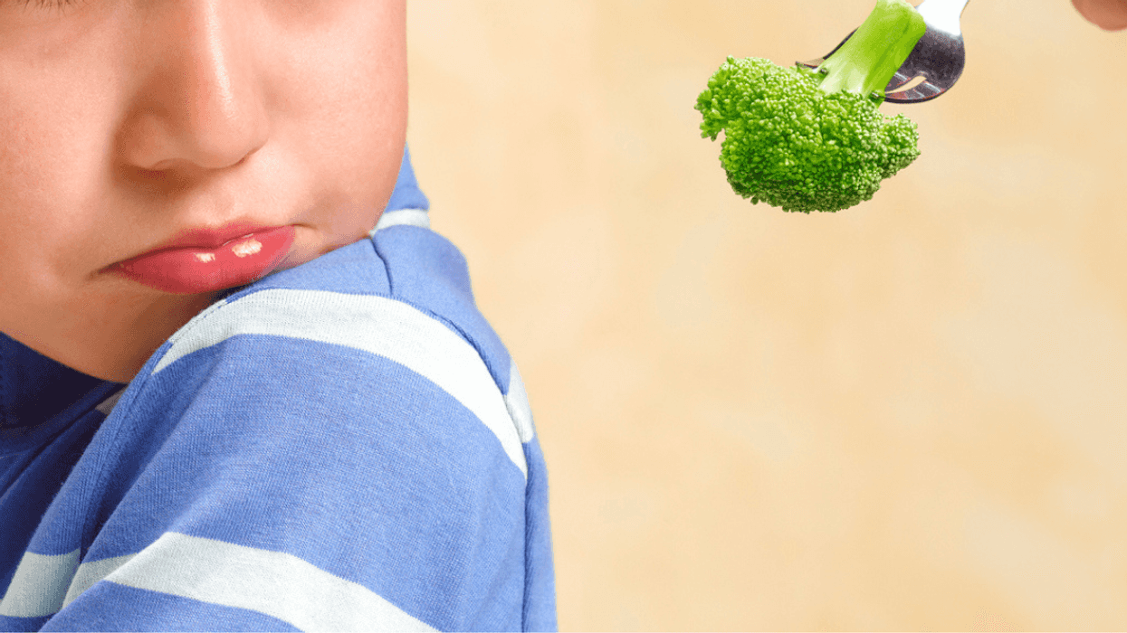 boy being fed broccoli