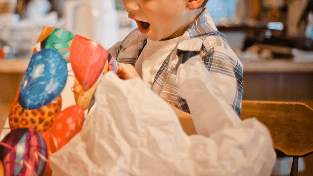 Boy opening present at party