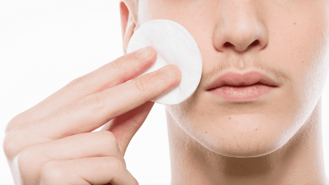 Boy putting on makeup