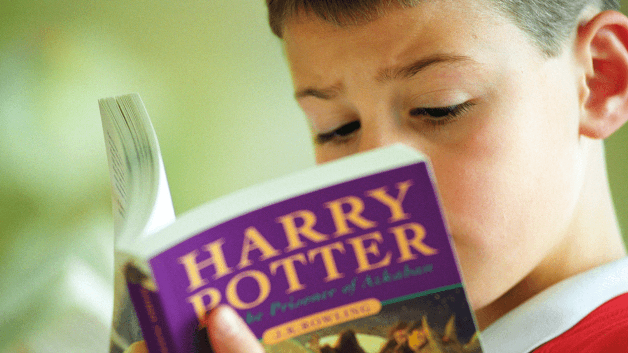 Boy reading 'Harry Potter'