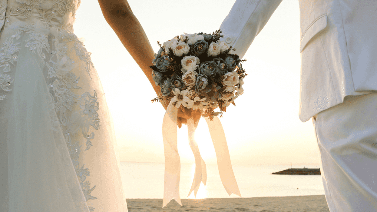 Bride and groom holding bridal bouquet