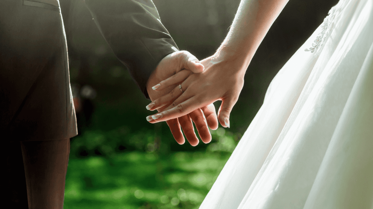 bride and groom holding hands