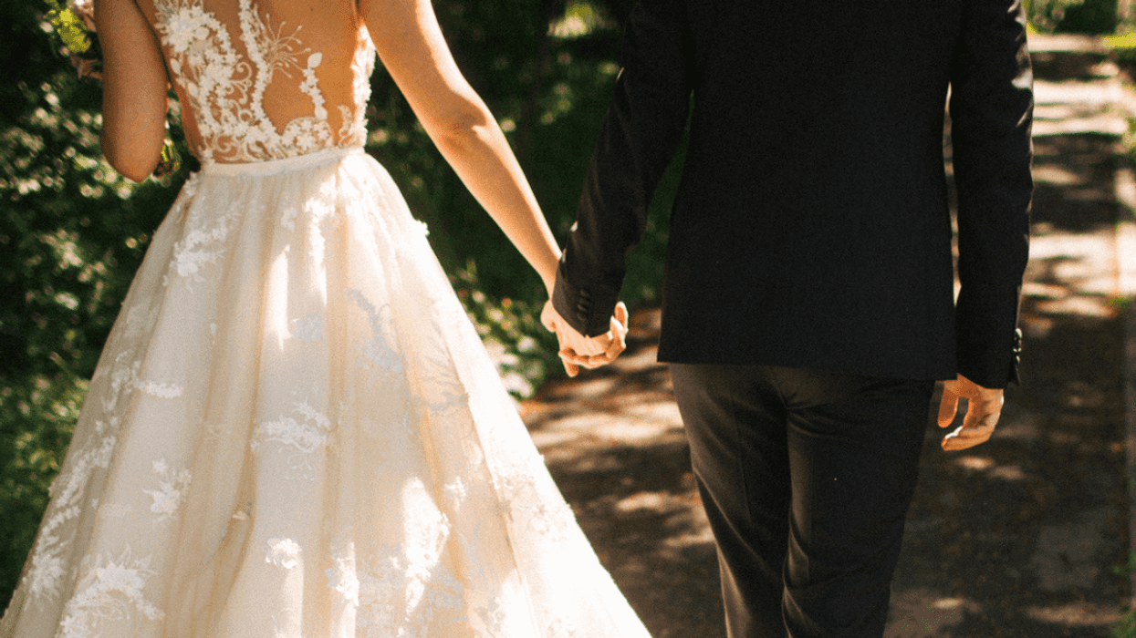 Bride and groom holding hands