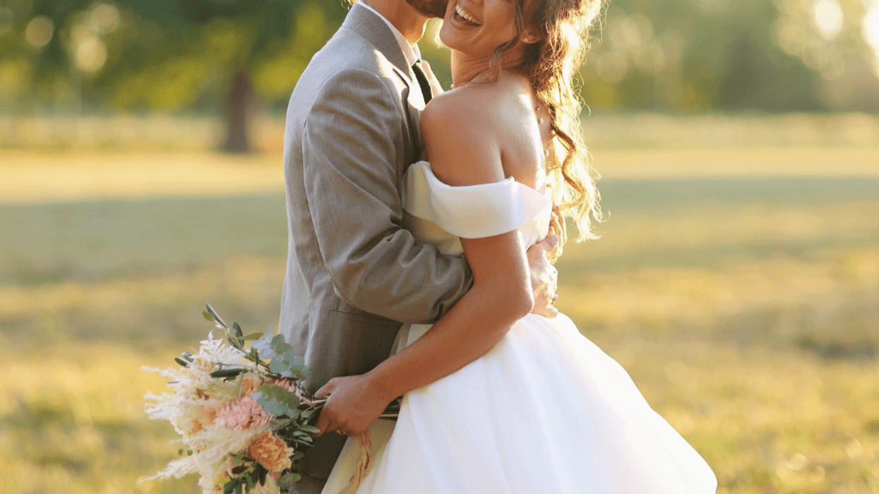 bride and groom in a field