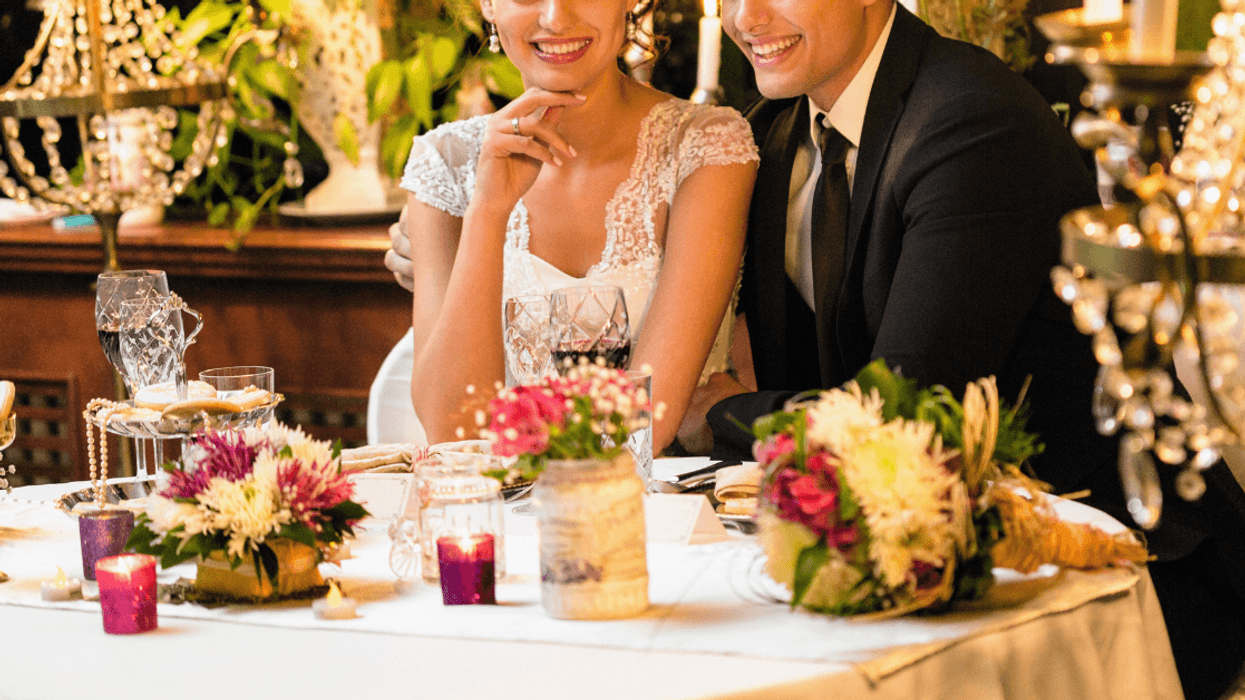 bride and groom seated at lavish table