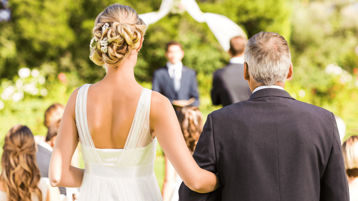 Bride being walked down the aisle