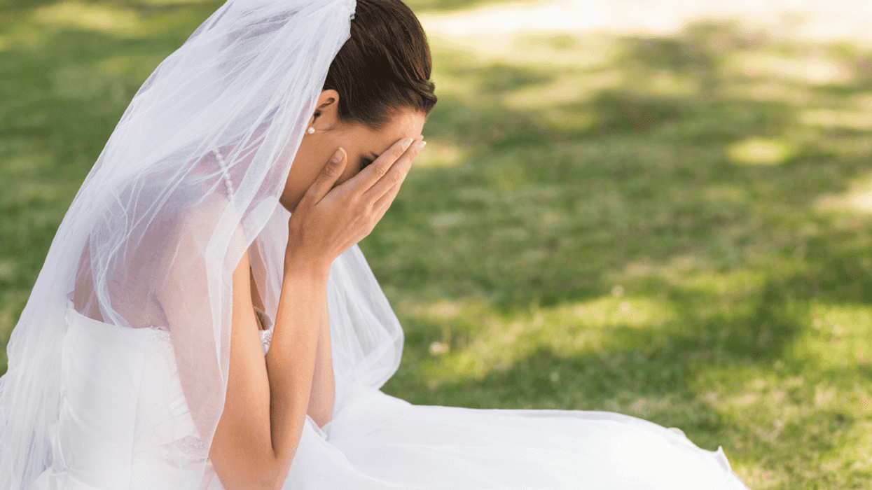 Bride crying into her hands