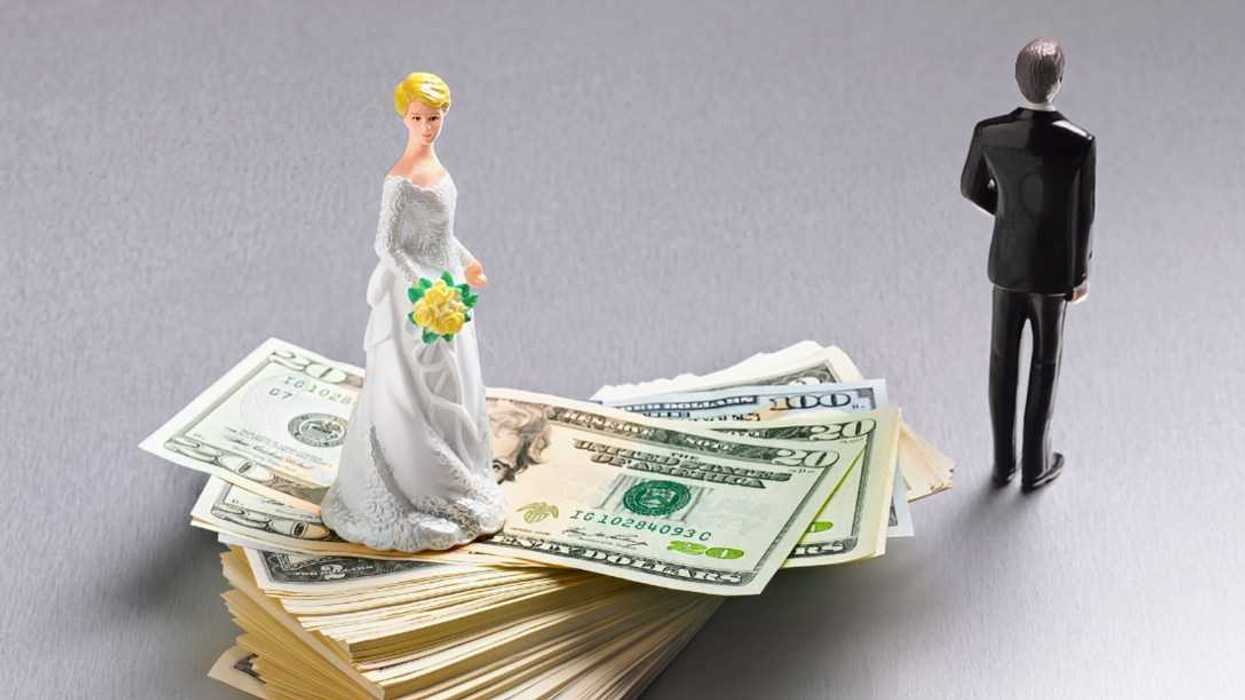 bride figurine on money with groom figurine turned away