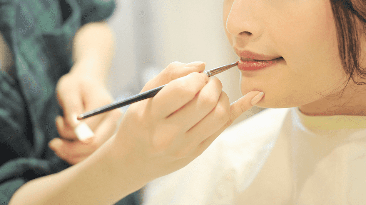 Bride getting her makeup done on her wedding day