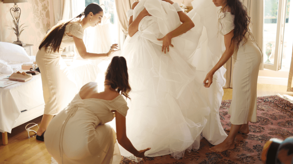 Bride getting ready in lavish wedding dress