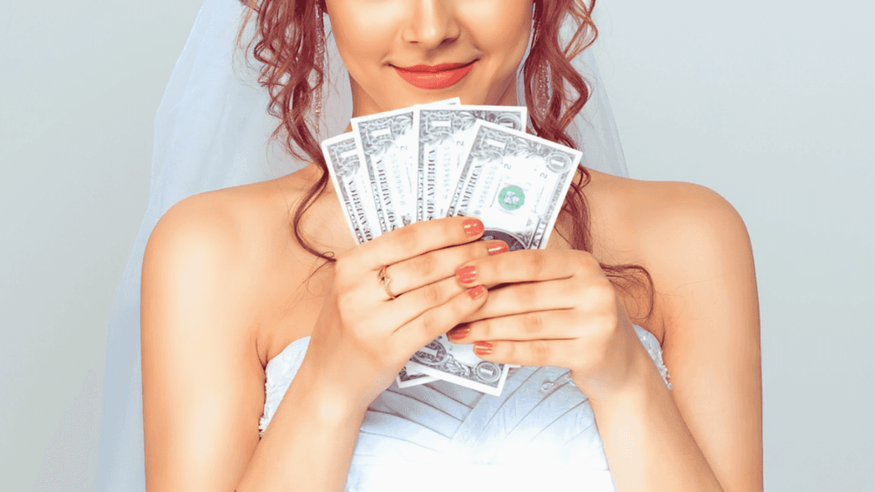 bride holding fanned cash