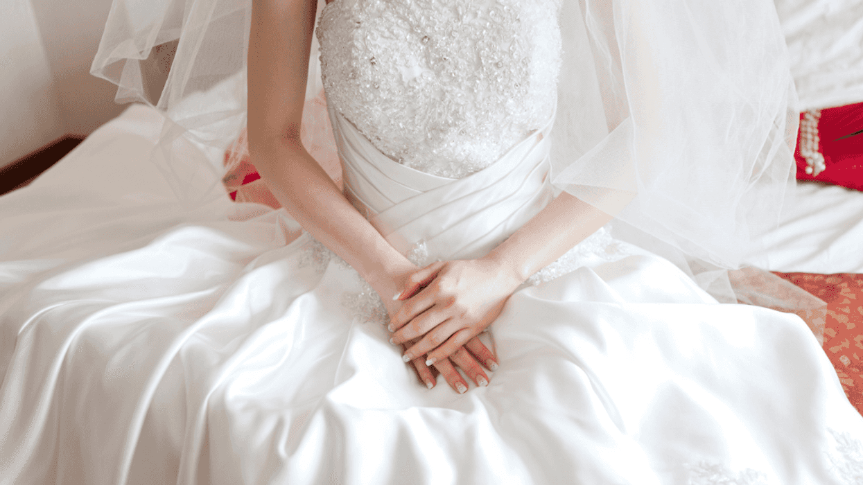 Bride sitting with hands crossed in her lap