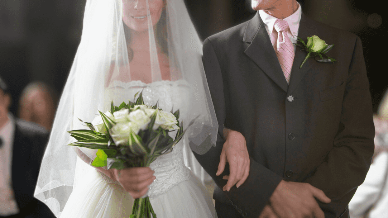 bride walks down aisle with older man