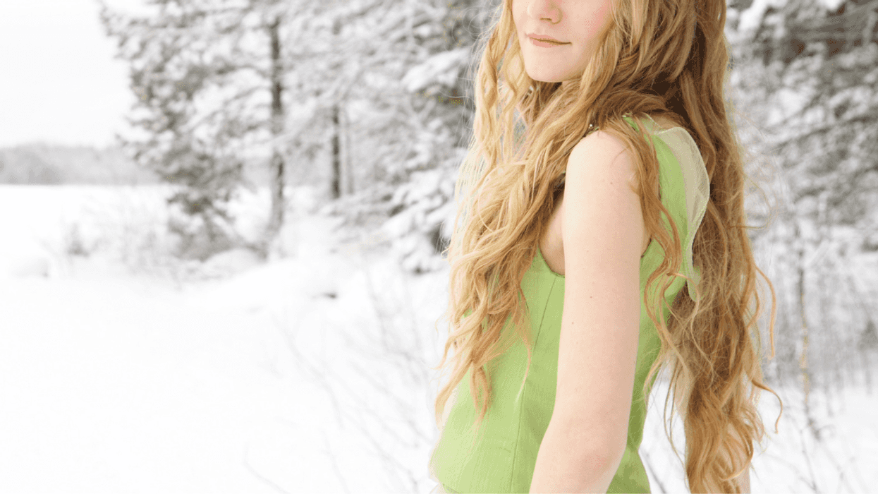 Bridesmaid standing in the snow with sleeveless dress