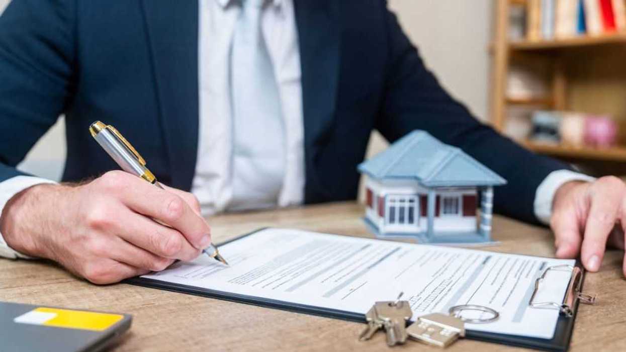 Businessman signing a real estate contract.