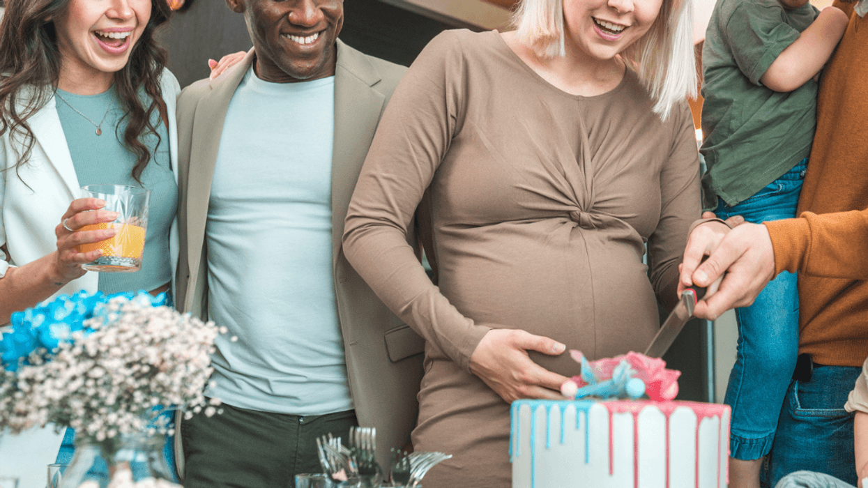 Cake being cut at a gender reveal party