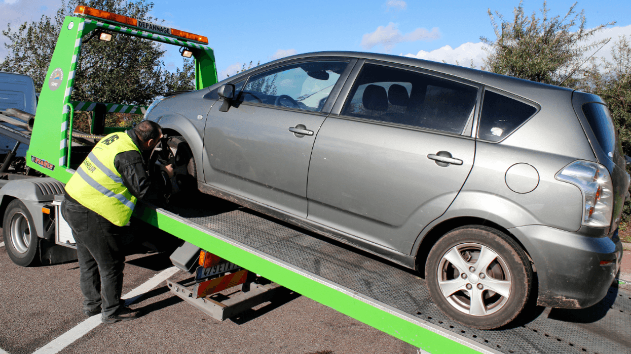 car being loaded on tow truck