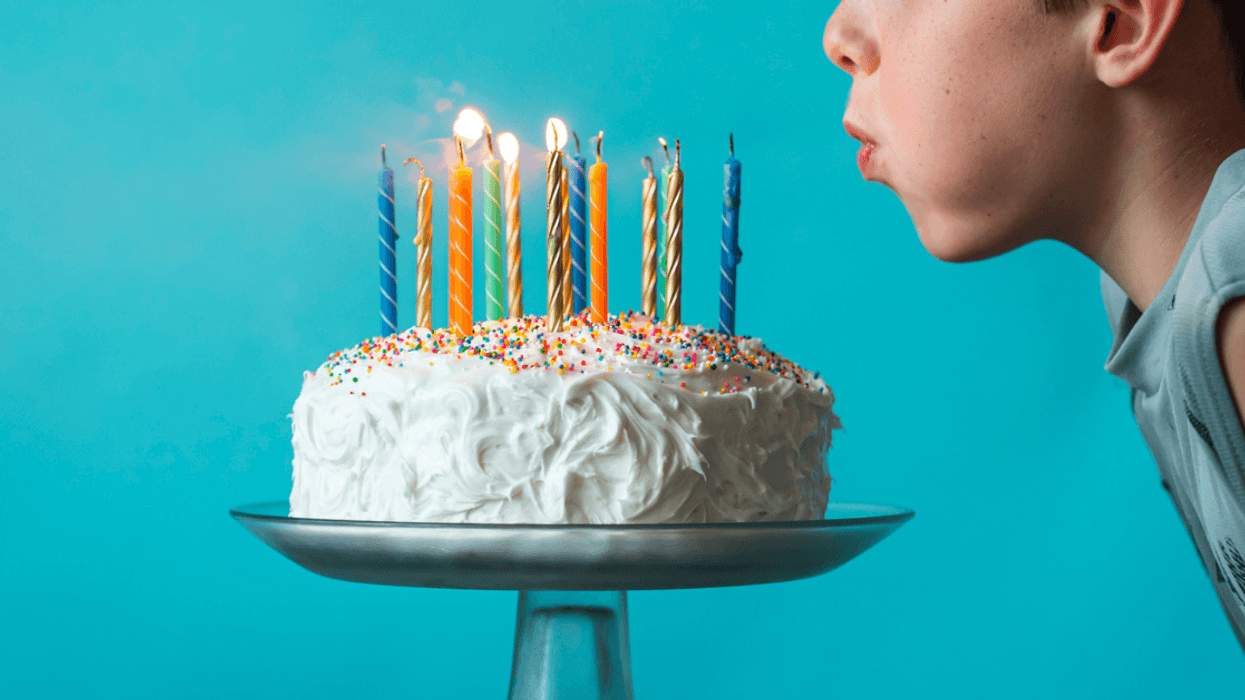 Child blowing out birthday candles