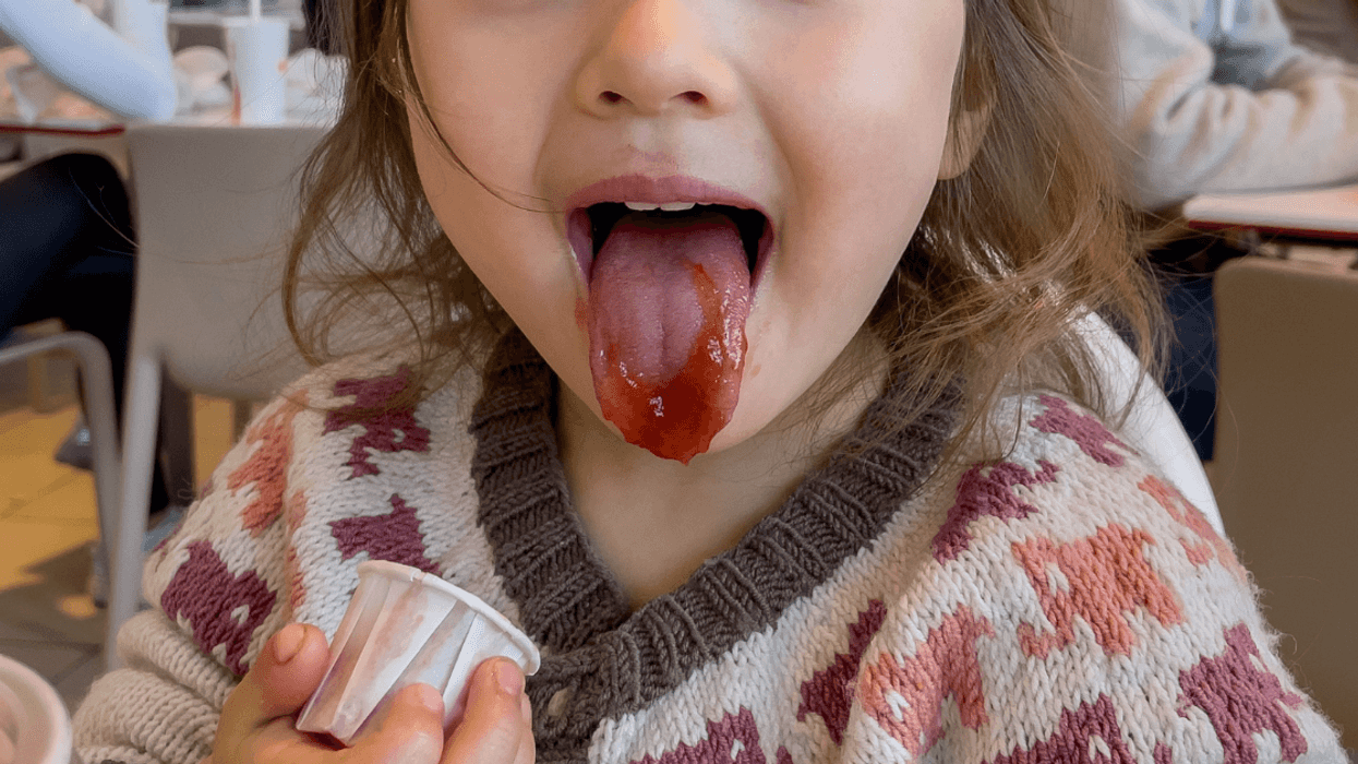 child eating ketchup