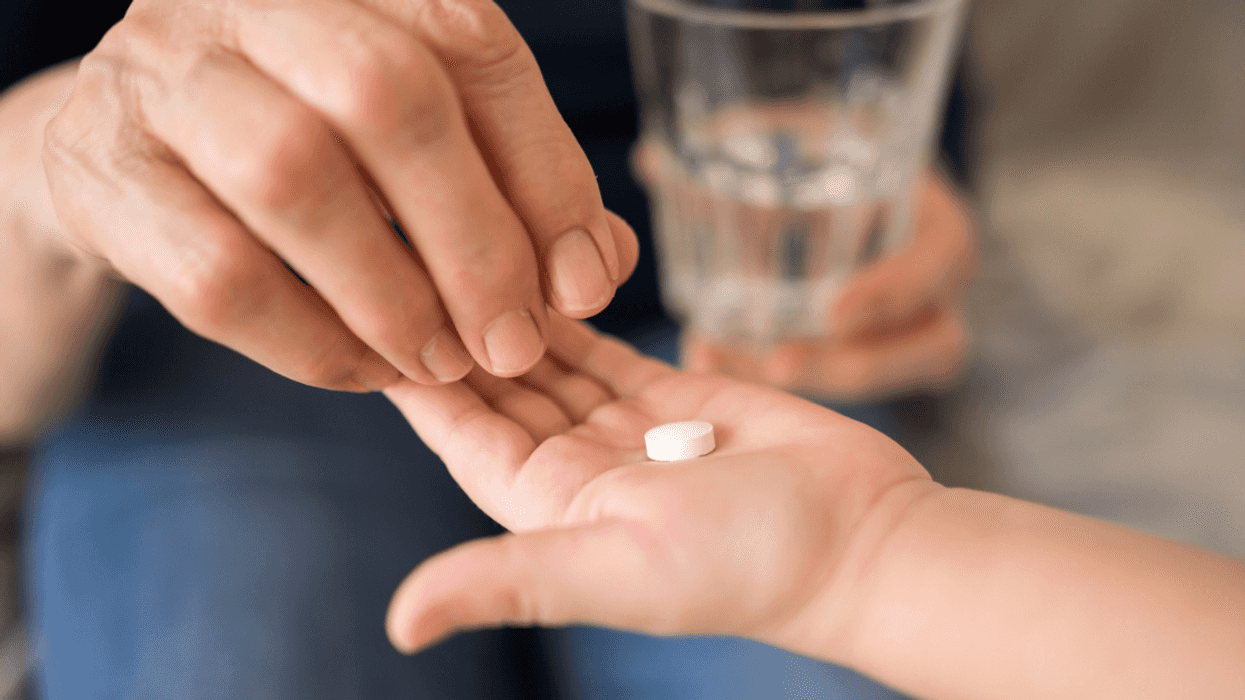 Child taking a melatonin pill