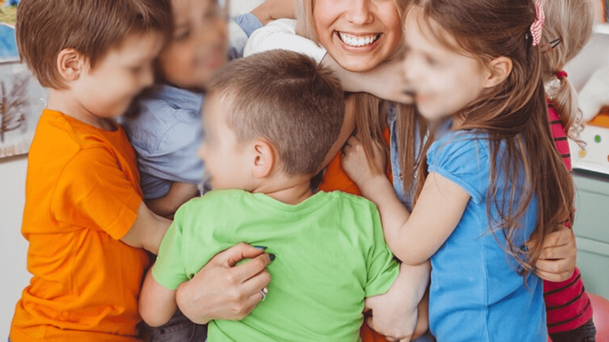 children hugging their teacher