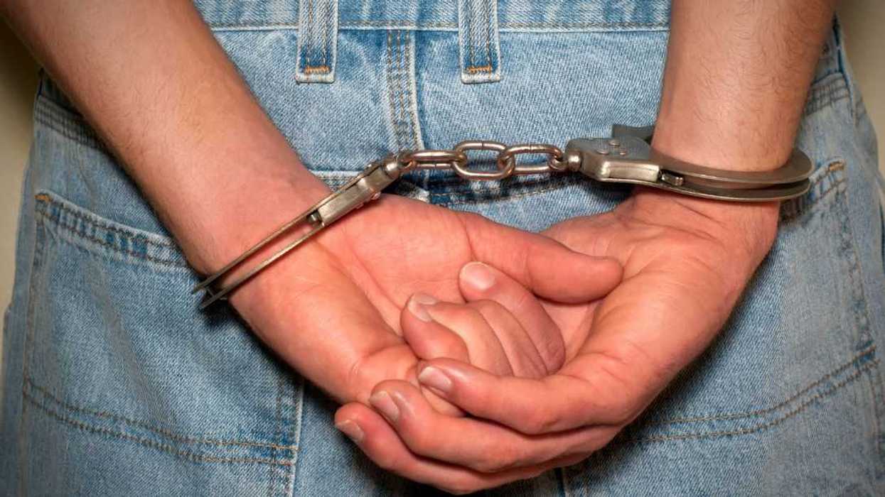 Close-up, back shot of a person in a pair of handcuffs.