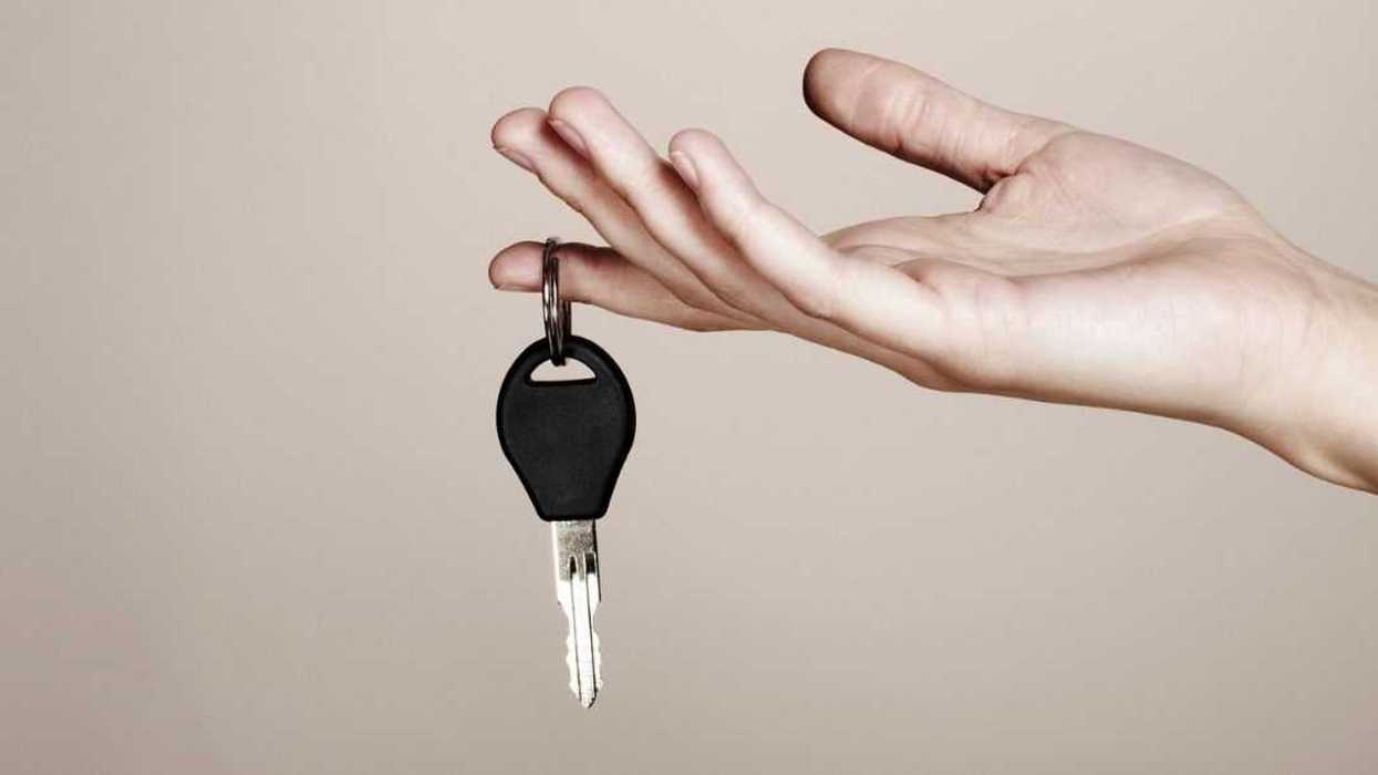 Close-up of a hand holding car key.
