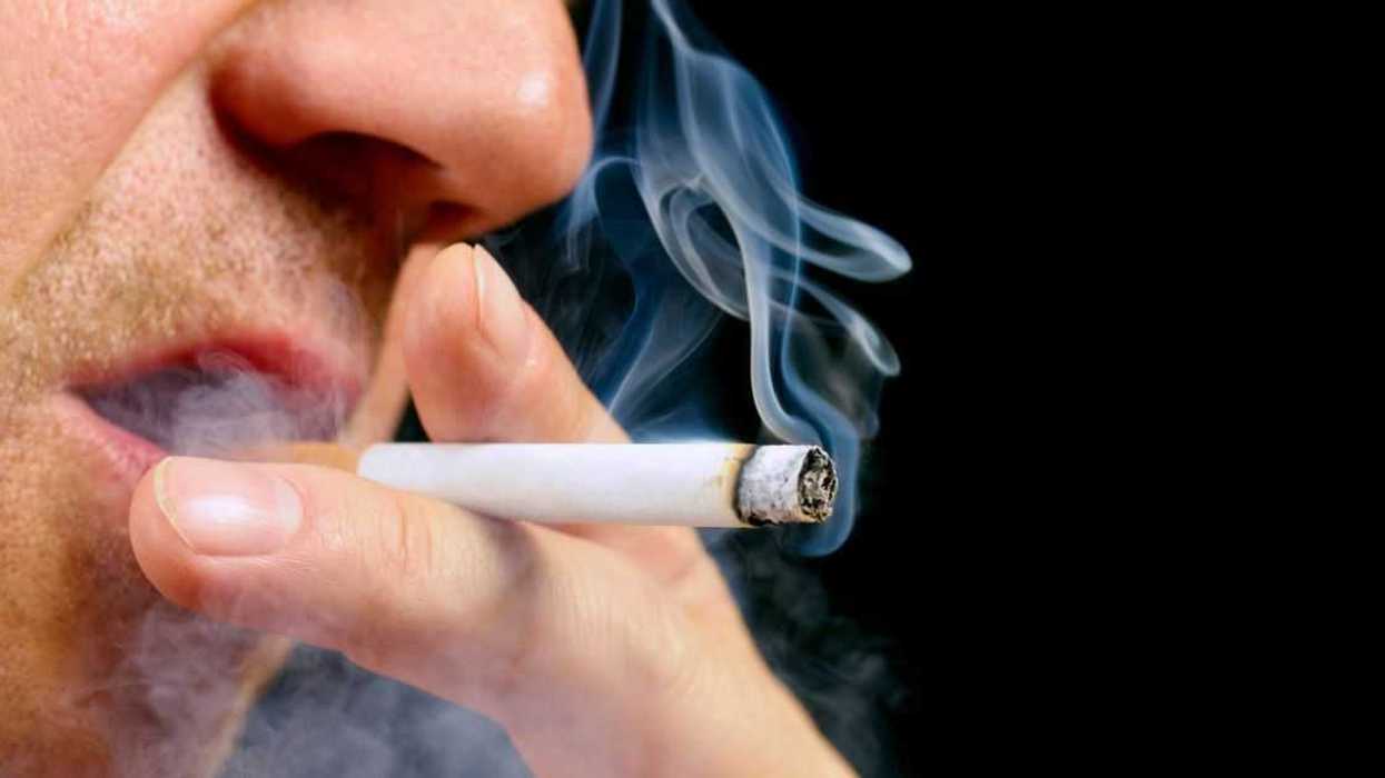 Close up of a man's mouth with with a cigarette