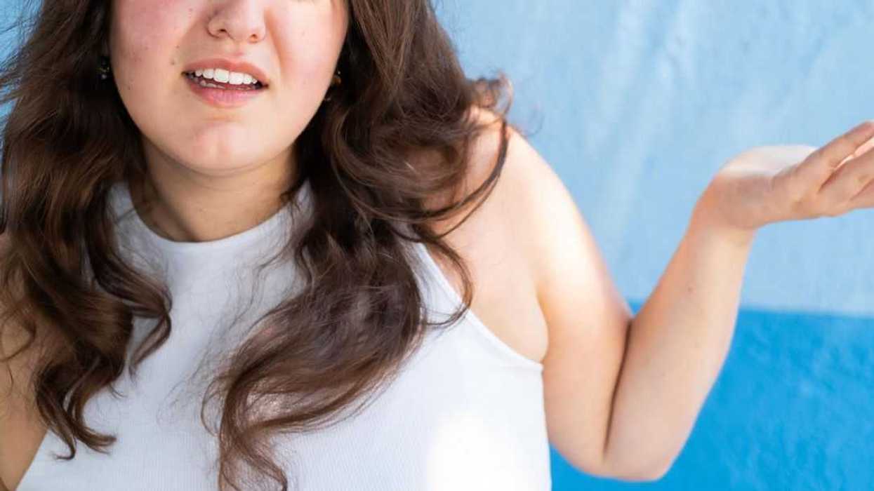 Close-up of a young woman making a face looking uncertain, confused, perplexed, WTF.