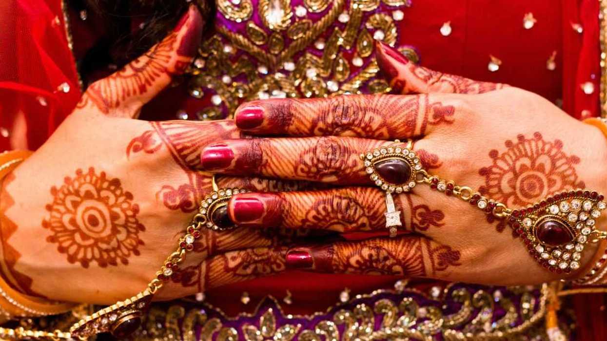 Close up of mehndi on a woman's hand.