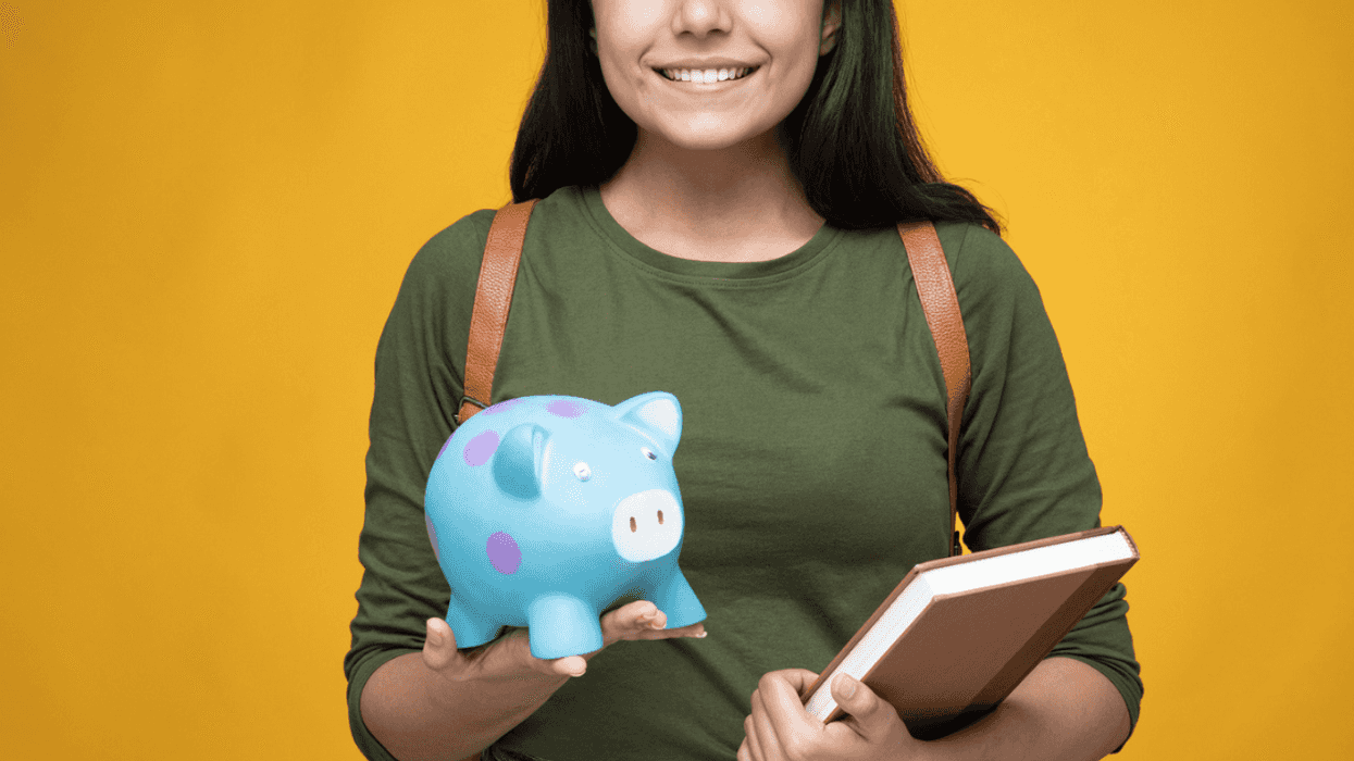 College student holding supplies and a piggy bank