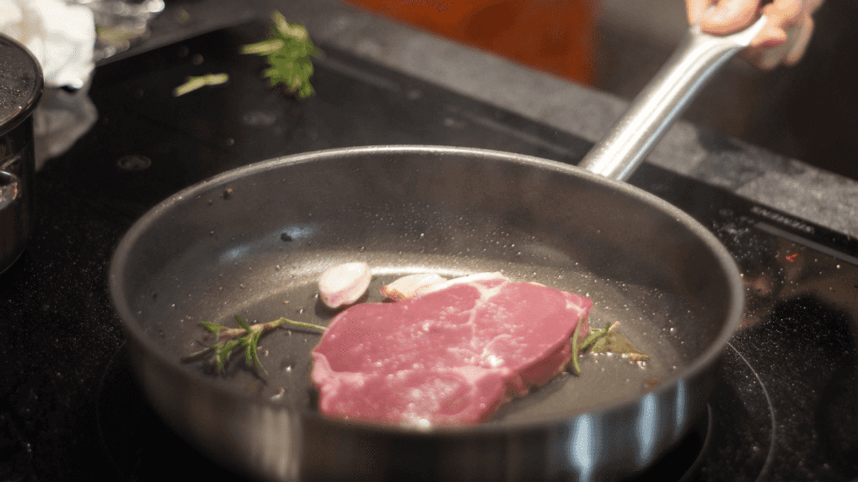 Cooking steak in a frying pan.