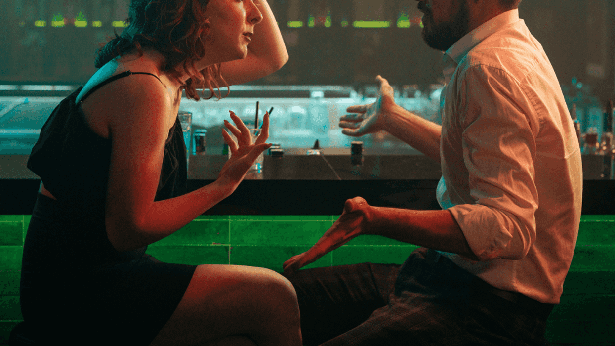 Couple arguing at a bar