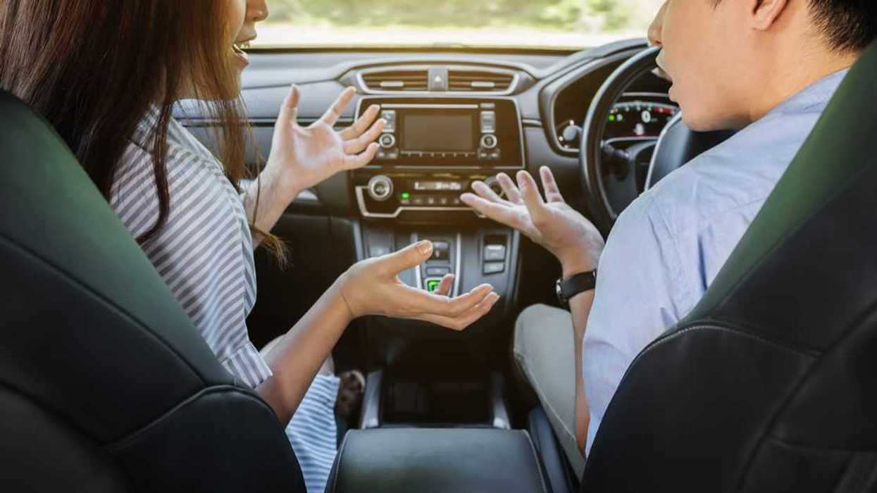 Couple arguing while driving a car.