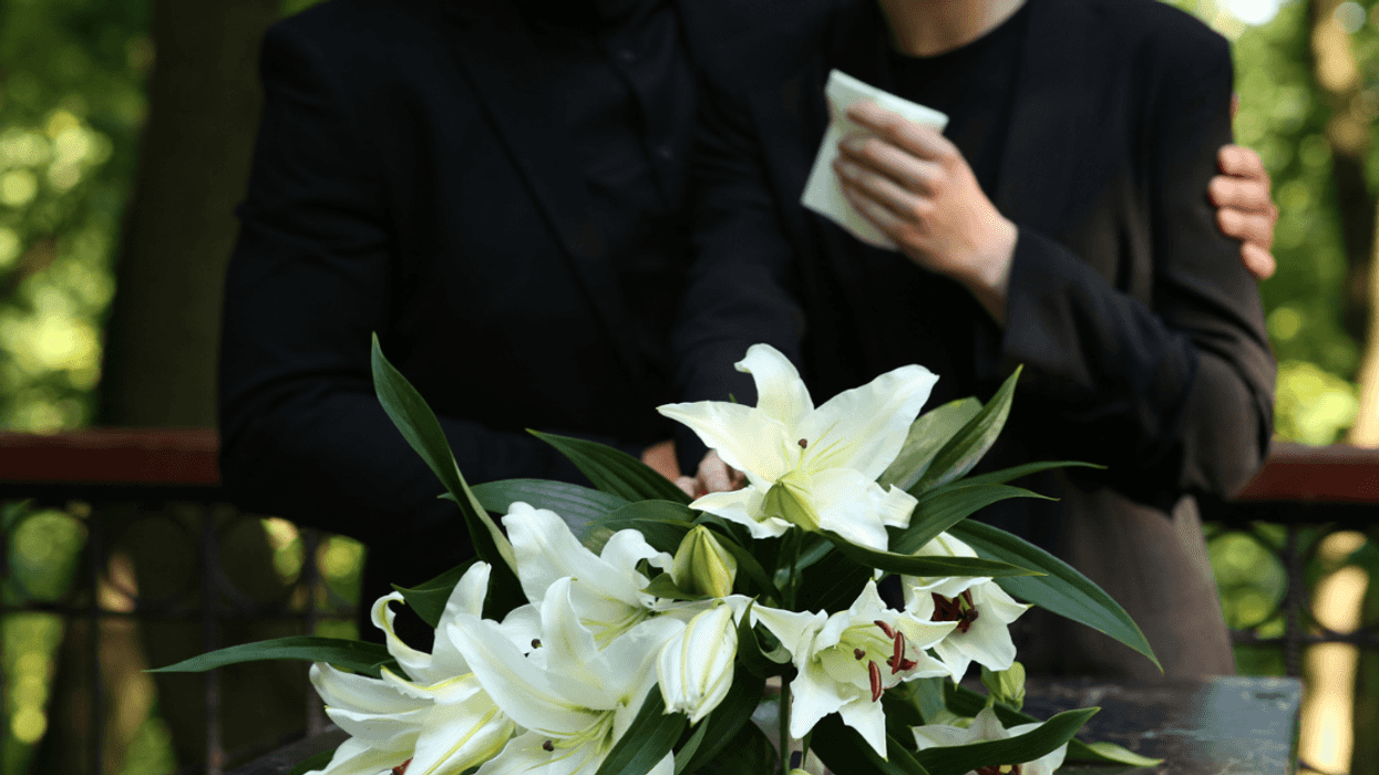 Couple grieving at graveyard