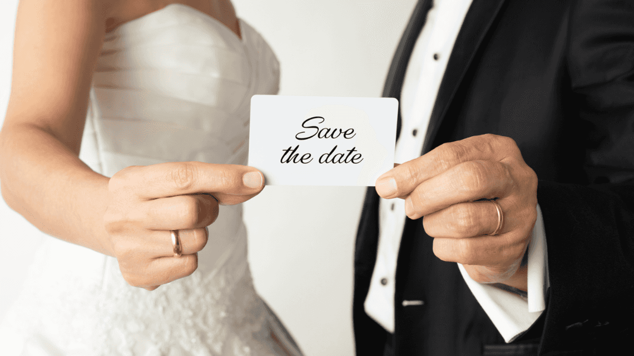Couple holding up 'Save the Date!' card