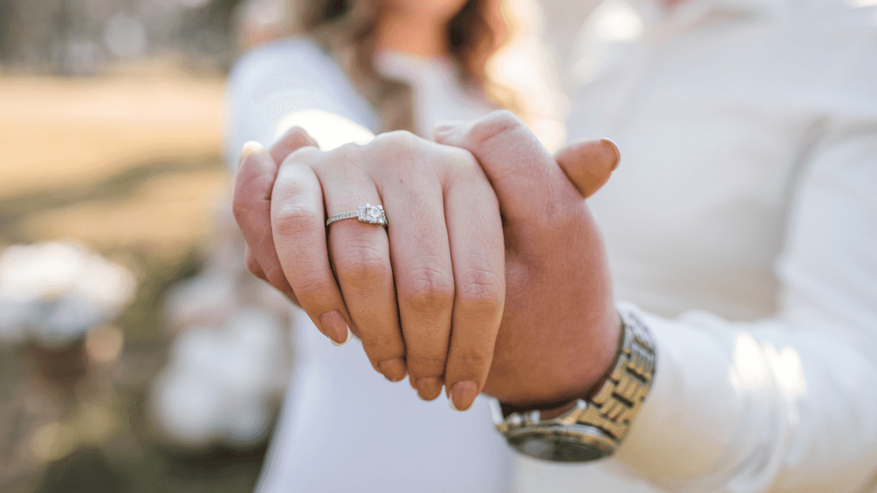 couple showing off an engagement ring