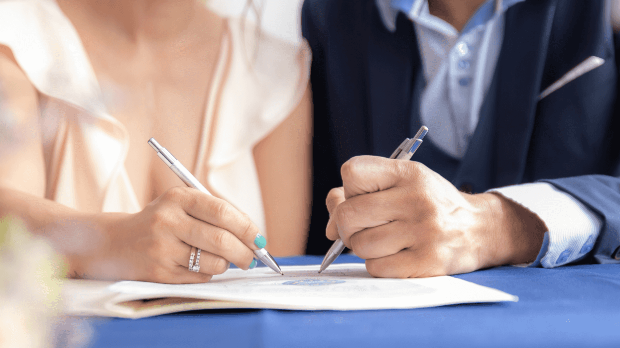 couple signing document together