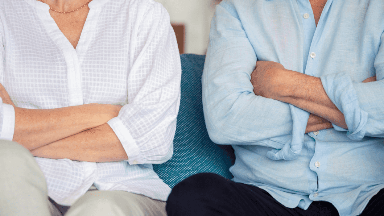 Couple sitting not speaking to each other.