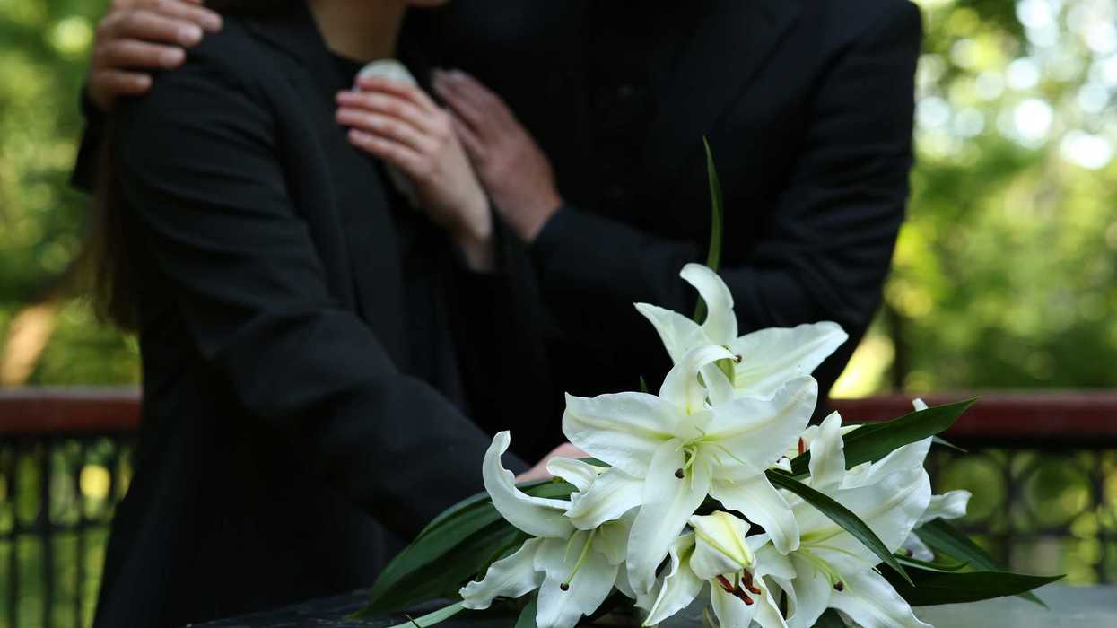 Couple standing together at funeral