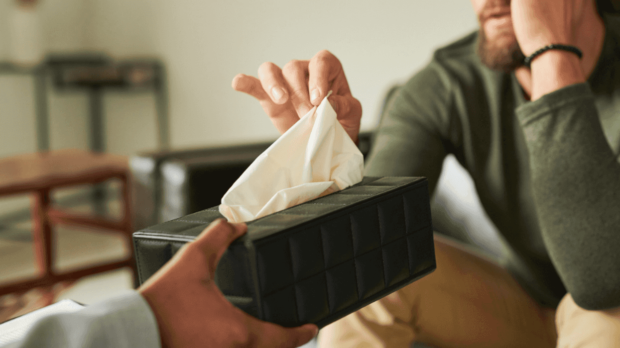 Crying person accepting tissues