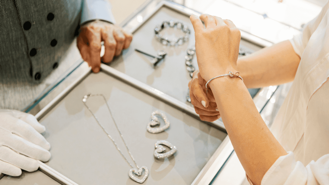 customer trying on bracelet at jewelry store