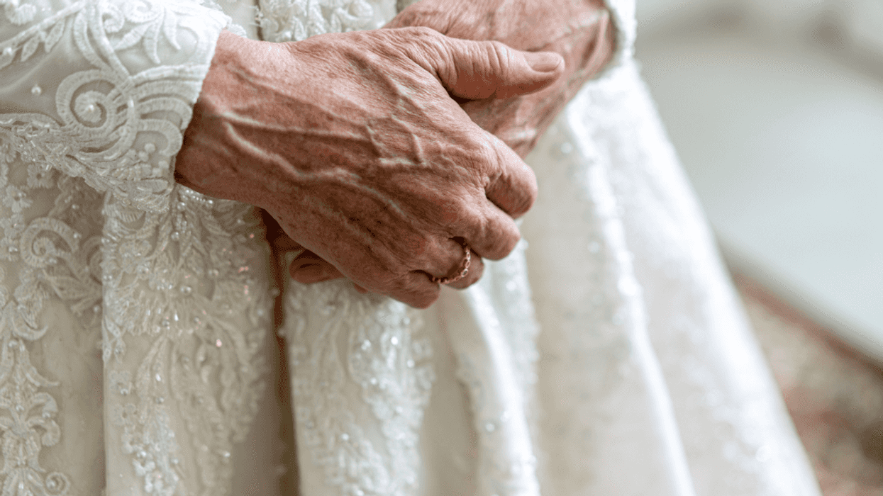 Elderly bride with her hands clasped.